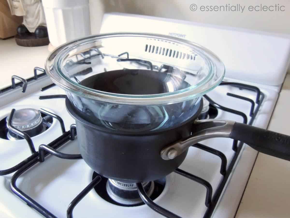 Homemade double boiler made with a small sauce pan and a glass bowl.