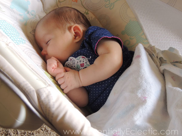 Breastfed baby with reflux asleep in a sleeper.