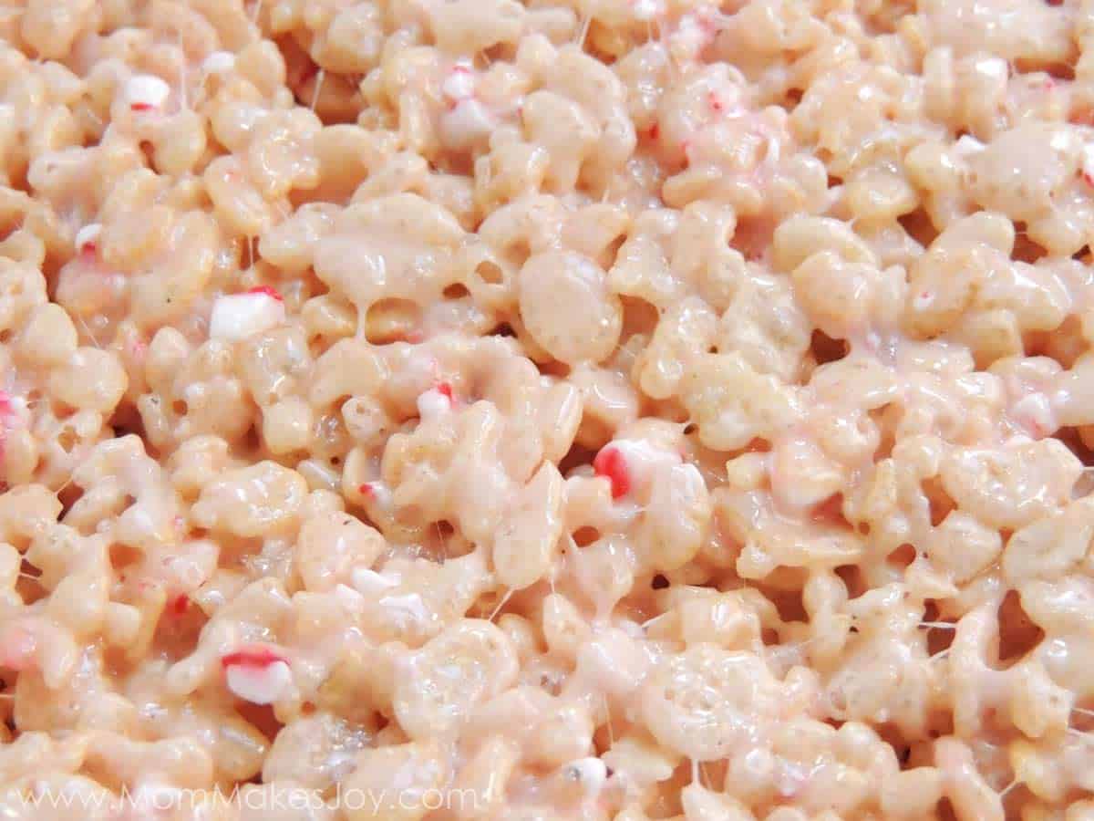 Candy Cane Rice Krispie Treats pressed flat with parchment paper